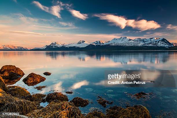 sunset sky over the mountains and the sea. - westelijke fjorden noorwegen stockfoto's en -beelden