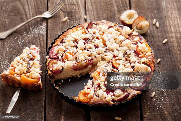 plum cake with pine nuts - dessertpasteten stock-fotos und bilder