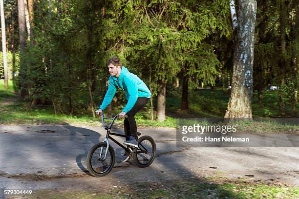 a bmx rider in a park - bmx park stock pictures, royalty-free photos & images