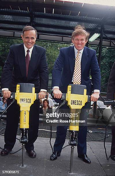 American politician and New York City Mayor Rudy Giuliani and real estate developer Donald Trump poses with jackhammers at the groundbreaking for the...