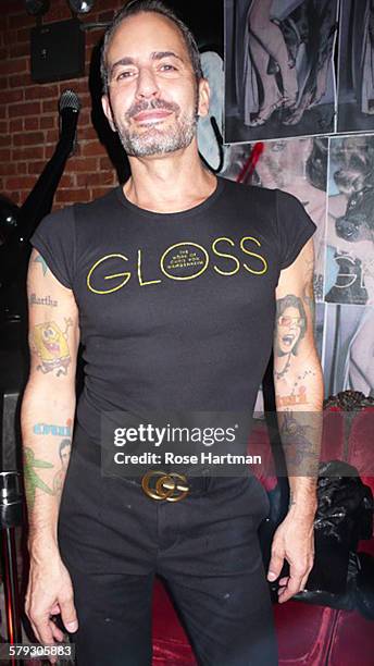American fashion designer Marc Jacobs, dressed in a black tank top the sports the logo for the book 'Gloss: The Work of Chris von Wangenheim,' poses...