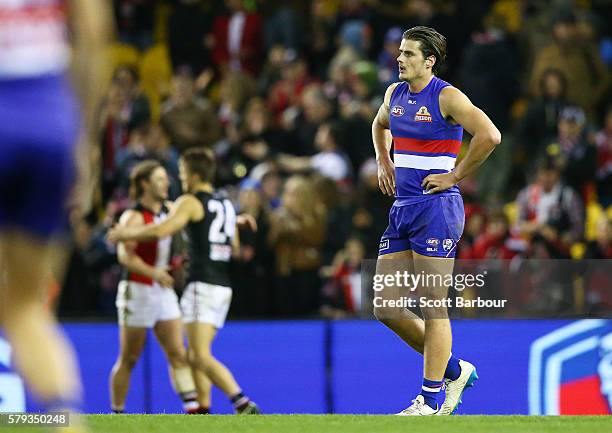 Tom Boyd of the Bulldogs and his teammates leave the field after losing the round 18 AFL match between the Western Bulldogs and the St Kilda Saints...