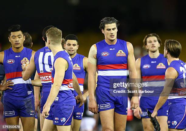 Tom Boyd of the Bulldogs and his teammates leave the field after losing the round 18 AFL match between the Western Bulldogs and the St Kilda Saints...