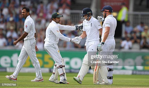 England batsman Joe Root is congratulated by Pakistan wicketkeeper Sarfraz Ahmed and Jonny Bairstow after being dismissed for 254 runs during day two...