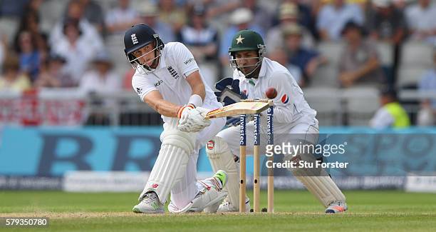 England batsman Joe Root sweeps to pick up some runs watched by Sarfraz Ahmed during day two of the 2nd Investec Test match between England and...