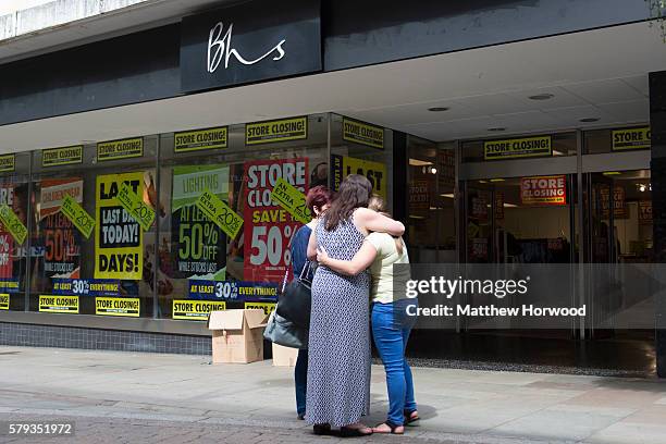 Workers hug outside the BHS store on Commercial Street on July 23, 2016 in Newport, Wales. The store is one of 20 stores across the UK to close...