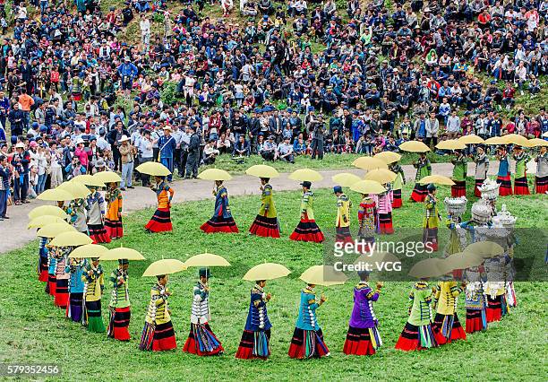 Villagers and visitors watch girls' beauty contests during the Torch Festival in Butuo county on July 22, 2016 in Liangshan Yi Autonomous Prefecture,...