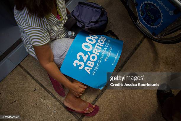 Woman sits in the shade during a Pro-Life Coalition of Pennsylvania's "Mercy Witness For Life" rally on July 23, 2016 outside of the former site of...