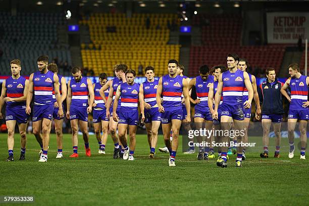 Easton Wood of the Bulldogs leads his side from the field after losing the round 18 AFL match between the Western Bulldogs and the St Kilda Saints at...