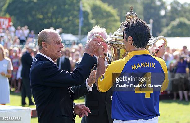 Prince Philip, Duke of Edinburgh and Fred Mannix attend the Royal Salute Coronation Cup at Guards Polo Club on July 23, 2016 in Egham, England.