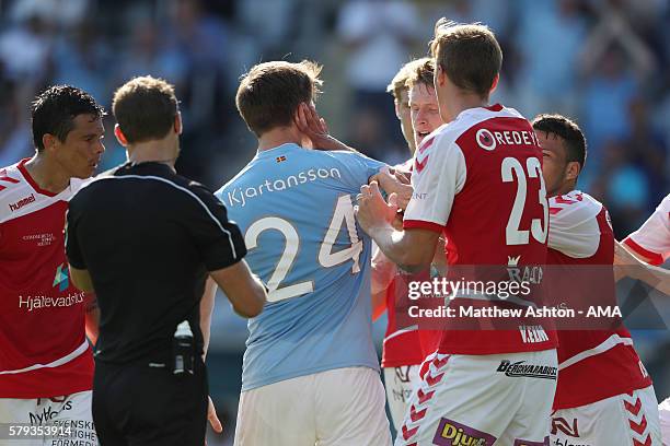 Vidar Kjartansson of Malmo FF gets slapped in the face by a Kalmar player after retrieving the ball out of the net after scoring the equalising goal...