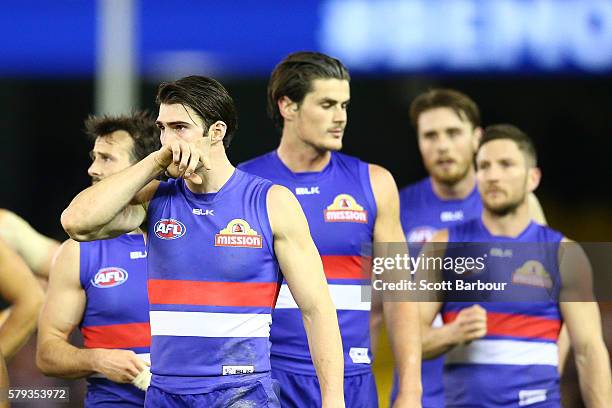 Easton Wood of the Bulldogs leads Tom Boyd and his teammates from the field after losing the round 18 AFL match between the Western Bulldogs and the...