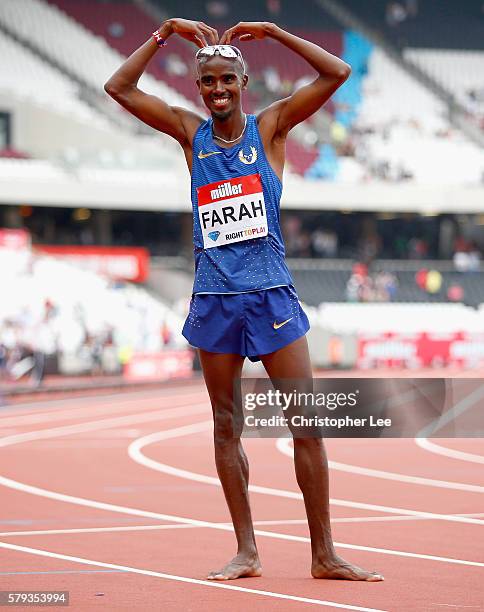 Mo Farah of Great Britain poses for the camera's as he celebrates winning the Mens 5000m during Day Two of the Muller Anniversary Games at The...