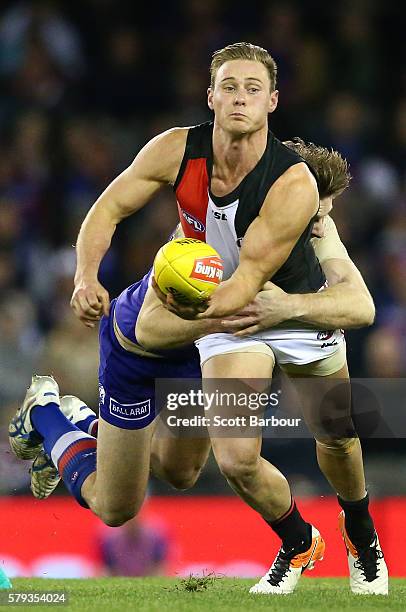 David Armitage of the Saints is tackled during the round 18 AFL match between the Western Bulldogs and the St Kilda Saints at Etihad Stadium on July...