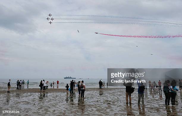 Spectators gather on the beach to watch the RAF Red Arrows perform during the 28th Sunderland International Air show on July 23, 2016 in Sunderland,...