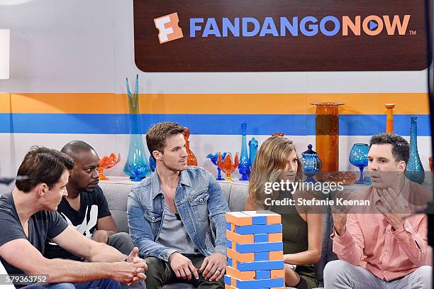 Goran Visnjic, Malcolm Barrett and Matt Lanter of NBC's "Timeless" play "Fan-Jenga" with Fandango hosts Nikki Novak and Kristian Harloff at the...