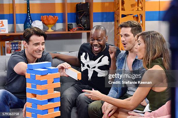 Goran Visnjic, Malcolm Barrett and Matt Lanter of NBC's "Timeless" play "Fan-Jenga" with Fandango hosts Nikki Novak and Kristian Harloff at the...