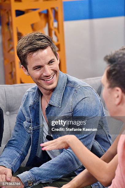 Matt Lanter of NBC's "Timeless" plays "Fan-Jenga" with Fandango hosts Nikki Novak and Kristian Harloff at the Fandango Studio at San Diego Comic-Con...