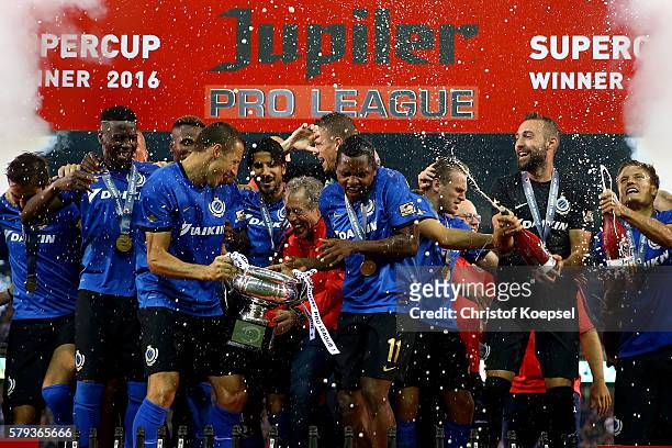 Head coach Michel Preud'homme of Brugge lifts the trophy with his team on the podium after winning 2-1 the Supercup match between Club Brugge and...