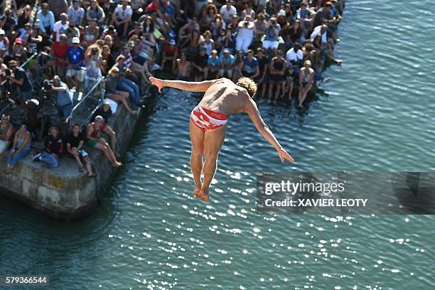 Kris Kolanus from Poland dives from the 27.5 metre high platform on the Saint-Nicolas tower during the Red Bull Cliff Diving World Series on July 23,...