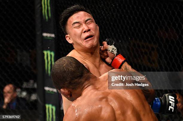 Alex Oliveira of Brazil punches James Moontasri in their welterweight bout during the UFC Fight Night event at the United Center on July 23, 2016 in...