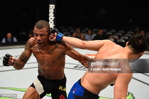 James Moontasri punches Alex Oliveira of Brazil in their welterweight bout during the UFC Fight Night event at the United Center on July 23, 2016 in...