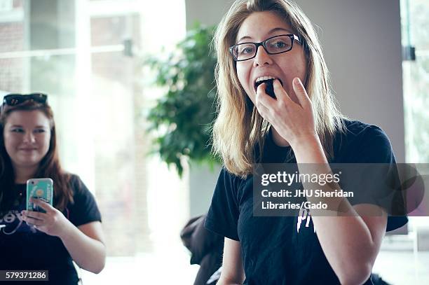 An undergraduate college student eats cake during Johns Hopkins University's annual "Read It And Eat It" Edible Book Festival on the Homewood campus...