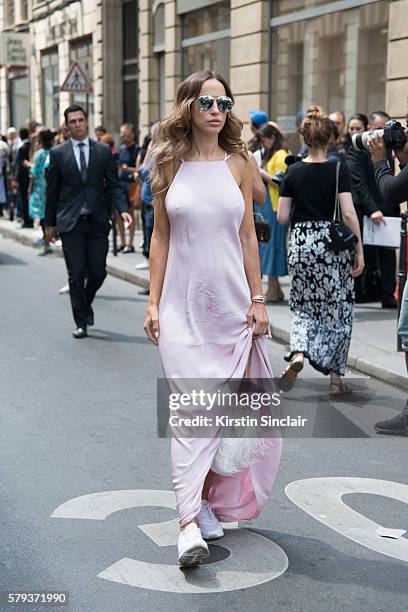 Fashion journalist Milana Koroleva wears an Isetta dress, Elie Saab bag, Dior sunglasses and Nike sneakers day 4 of Paris Haute Couture Fashion Week...