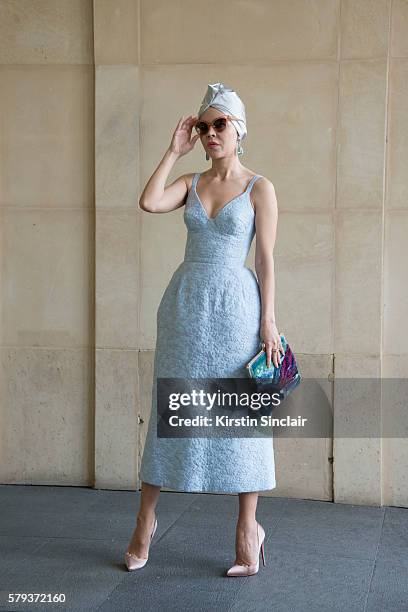 Fashion designer Ulyana Sergeenko wears an Ulyana Sergeenko dress and bag and Christian Louboutin shoes day 4 of Paris Haute Couture Fashion Week...