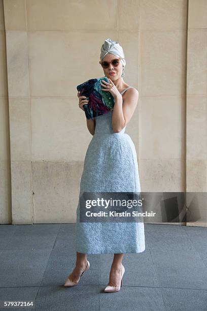 Fashion designer Ulyana Sergeenko wears an Ulyana Sergeenko dress and bag and Christian Louboutin shoes day 4 of Paris Haute Couture Fashion Week...