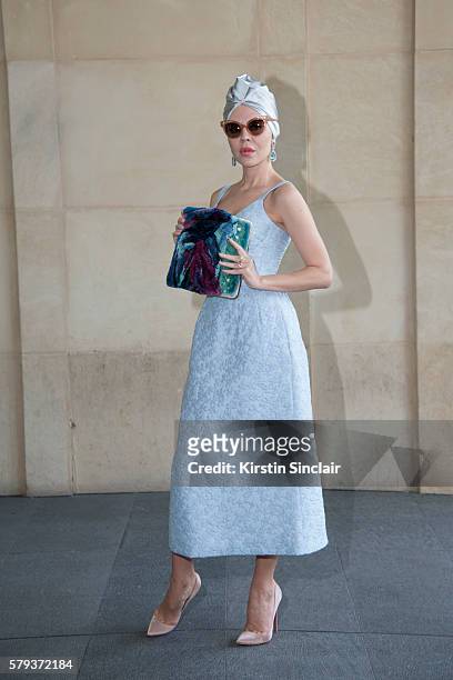 Fashion designer Ulyana Sergeenko wears an Ulyana Sergeenko dress and bag and Christian Louboutin shoes day 4 of Paris Haute Couture Fashion Week...