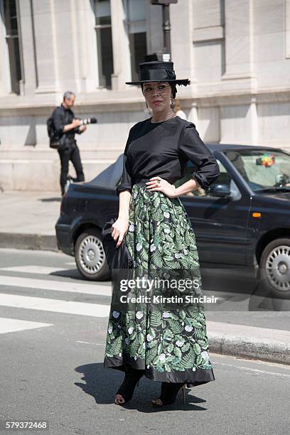 Fashion designer Ulyana Sergeenko wears an Ulyana Sergeenko blouse and skirt, Steven Jones hat and Guiseppe Zamotti shoes day 4 of Paris Haute...
