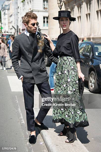 Marketing director Frol Burimskiy with Fashion designer Ulyana Sergeenko wearing an Ulyana Sergeenko blouse and skirt, Steven Jones hat and Guiseppe...