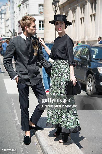 Marketing director Frol Burimskiy with Fashion designer Ulyana Sergeenko wearing an Ulyana Sergeenko blouse and skirt, Steven Jones hat and Guiseppe...