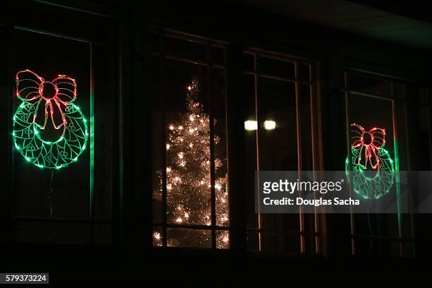 festive christmas holiday window display with colorful lights - globe showing north america stock pictures, royalty-free photos & images