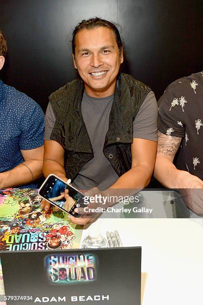Actor Adam Beach from the cast of Suicide Squad film participates in an autograph session for fans in DC's 2016 Comic-Con booth at San Diego...
