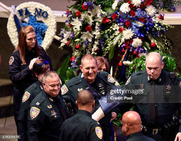 Wounded East Baton Rouge Sheriff sergeant Bruce Simmons, smiles as he arrives at funeral services for deputy Brad Garafola at the Istrouma Baptist...