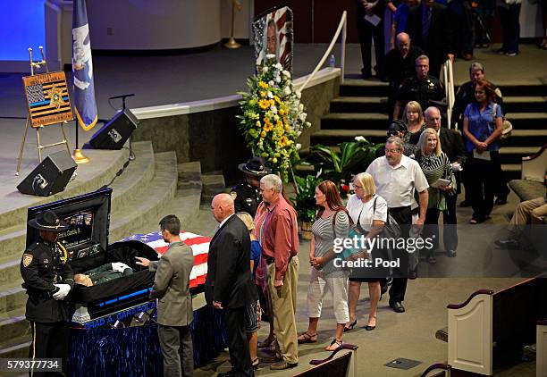 Mourners line up to view the body of East Baton Rouge Sheriff deputy Brad Garafola at the Istrouma Baptist Church in Baton Rouge, La., Saturday, July...