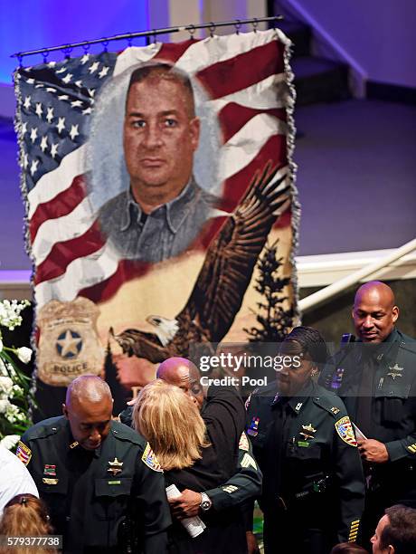 East Baton Rouge Sheriff deputies line up and comfort each other during the viewing of East Baton Rouge Sheriff deputy Brad Garafola at the Istrouma...