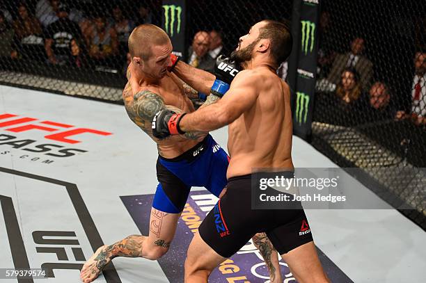 Eddie Wineland punches Frankie Saenz in their bantamweight bout during the UFC Fight Night event at the United Center on July 23, 2016 in Chicago,...