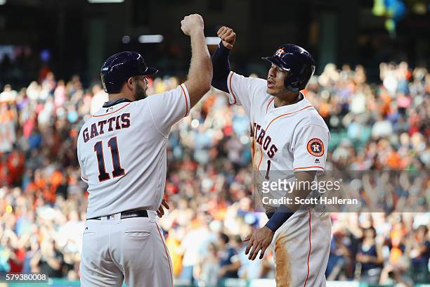 Evan Gattis and Carlos Correa of the Houston Astros celebrate after Evan Gattis hit a three-run home run in the second inning of their game against...