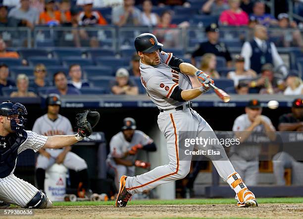 Mac Williamson of the San Francisco Giants hits an RBI single in the 12th inning as Brian McCann of the New York Yankees defends on July 23, 2016 at...