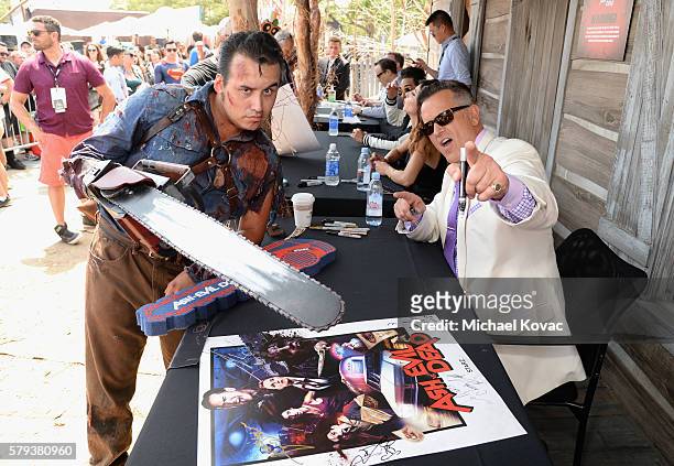 Actor Bruce Campbell with fan attends the "Ash vs Evil Dead" autograph signing during Comic-Con International 2016 at PETCO Park on July 23, 2016 in...