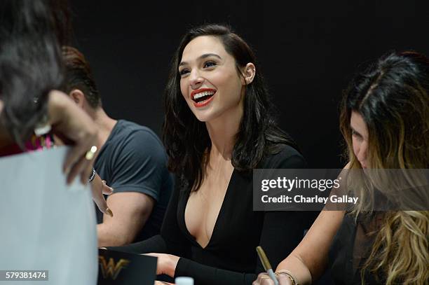 Actress Gal Gadot from the 2017 feature film Wonder Woman signs autographs for fans in DC's 2016 San Diego Comic-Con booth at San Diego Convention...