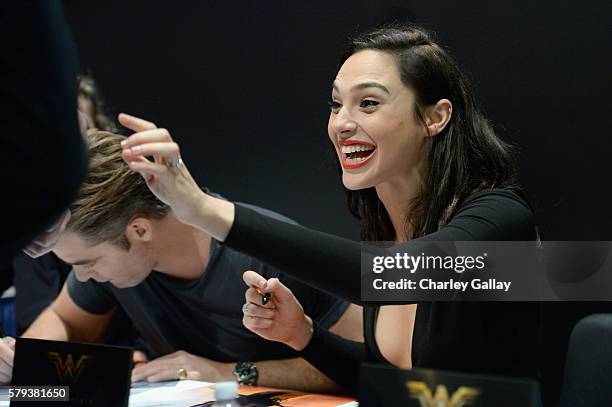 Actress Gal Gadot from the 2017 feature film Wonder Woman signs autographs for fans in DC's 2016 San Diego Comic-Con booth at San Diego Convention...