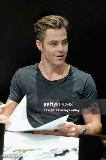 Actor Chris Pine from the 2017 feature film Wonder Woman signs autographs for fans in DC's 2016 San Diego Comic-Con booth at San Diego Convention...