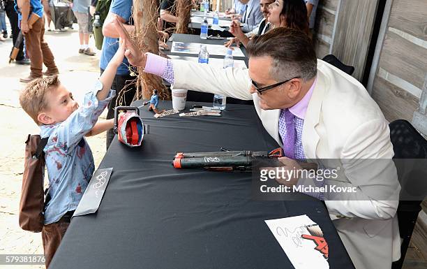 Actor Bruce Campbell with fan attends the "Ash vs Evil Dead" autograph signing during Comic-Con International 2016 at PETCO Park on July 23, 2016 in...