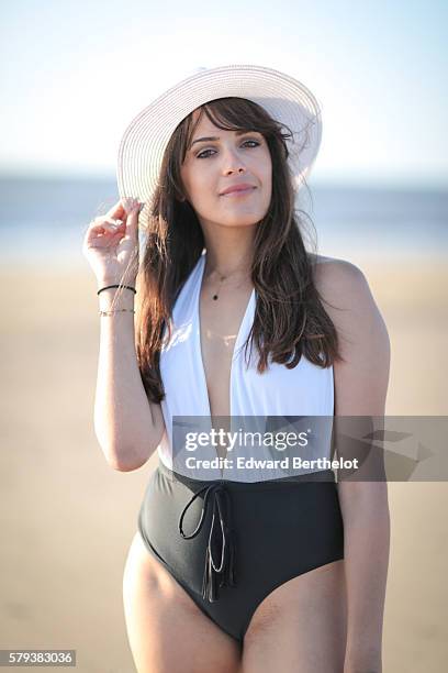 Sarah Benziane , is wearing a Miss Guided swim wear, L'usine a lunettes by Polette sunglasses, and a Newlook white hat, on the beach, on July 23,...