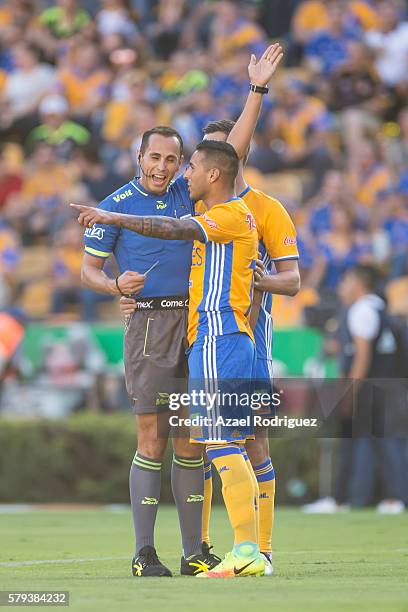 Referee Luis Santander gives a yellow card to Ismael Sosa of Tigres during the 2nd round match between Tigres UANL and Atlas as part of the Torneo...