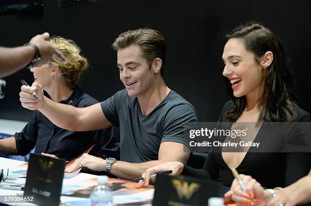 Actors Chris Pine and Gal Gadot from the 2017 feature film Wonder Woman sign autographs for fans in DC's 2016 San Diego Comic-Con booth at San Diego...